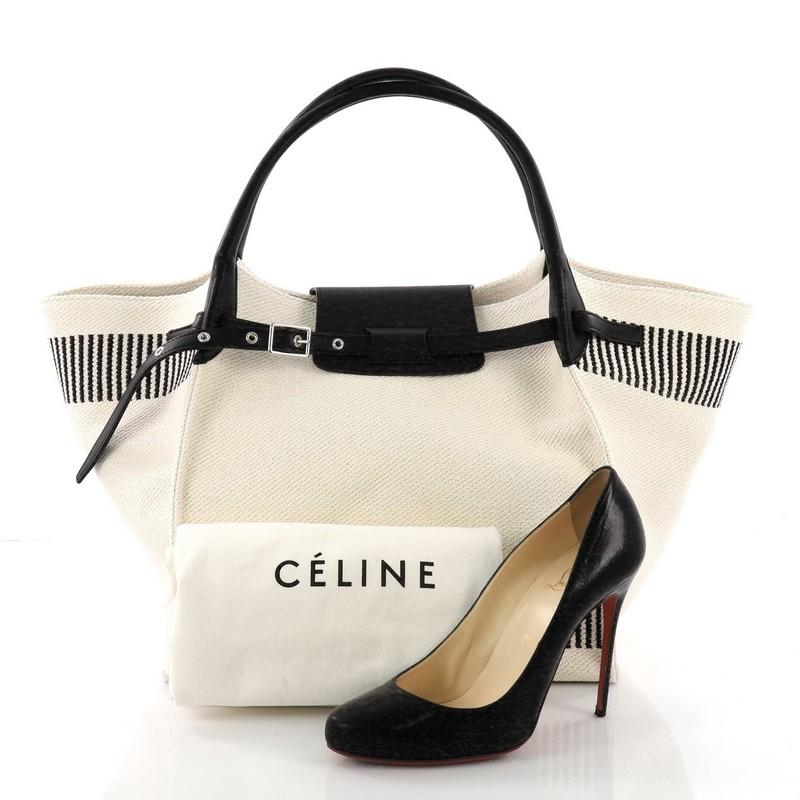 This Celine Big Bag Canvas Medium, crafted from beige canvas, features dual rolled handles, belt detail on the front and silver-tone hardware. It opens to a beige canvas interior with zip pocket. **Note: Shoe photographed is used as a sizing