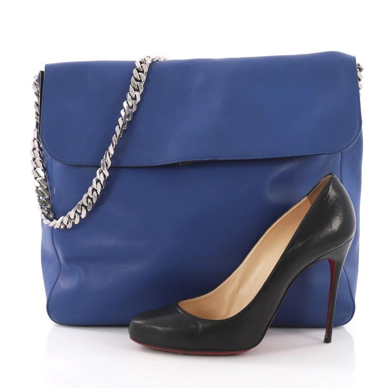 This Celine Gourmette Shoulder Bag Leather Small, crafted in blue leather, features a chain link strap, frontal flap, and silver-tone hardware. Its flap opens to a black suede interior with slip pocket. **Note: Shoe photographed is used as a sizing