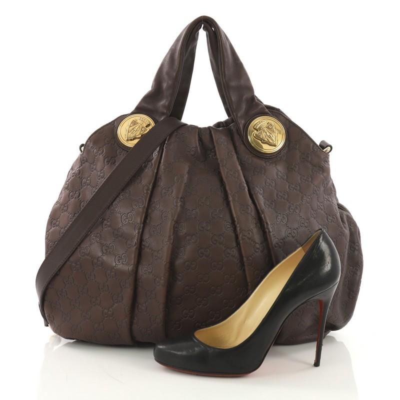 This Gucci Hysteria Convertible Top Handle Bag Guccissima Leather Large, crafted in brown guccissima leather, features dual flat leather handles, pleated silhouette and gold-tone hardware. Its magnetic snap closure opens to a printed fabric interior