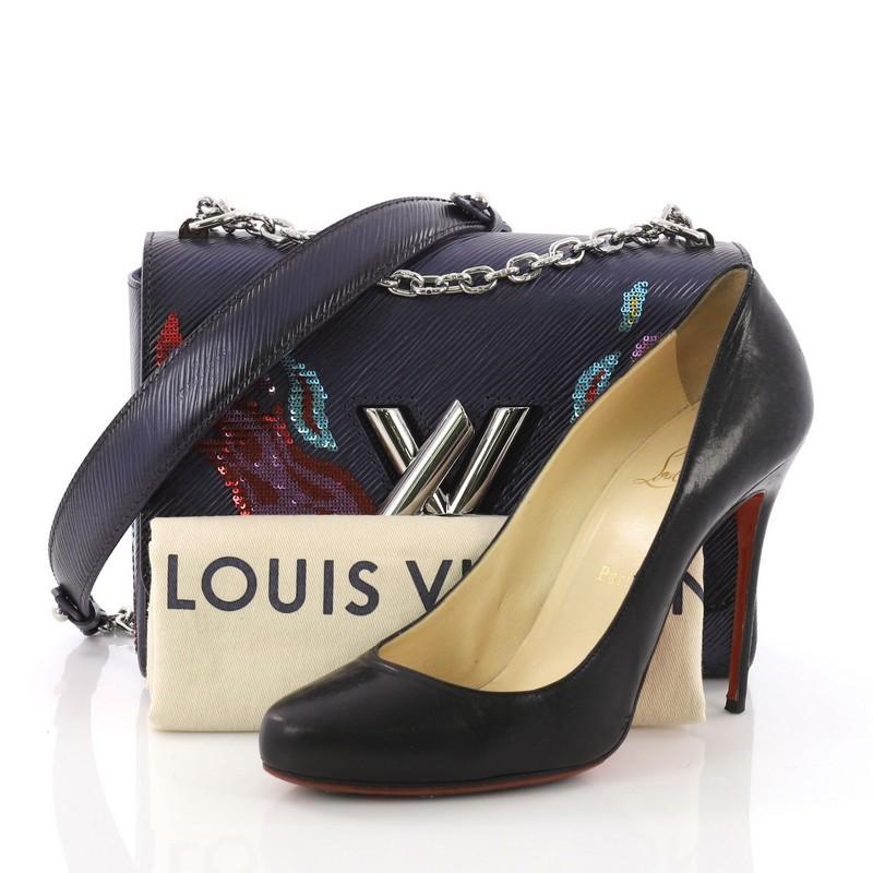 This Louis Vuitton Twist Handbag Epi Leather with Sequins MM, crafted in navy epi leather with multicolor sequins, features chain-link shoulder strap with leather pad, large LV twist closure and silver-tone hardware. Its twist-lock closure opens to