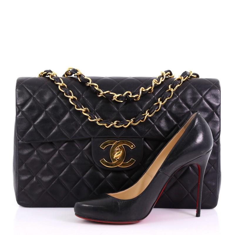 This Chanel Vintage Classic Single Flap Bag Quilted Lambskin Maxi, crafted in black quilted lambskin, features woven-in leather chain link straps, exterior back slip pocket, and gold-tone hardware. Its CC turn-lock closure opens to a burgundy