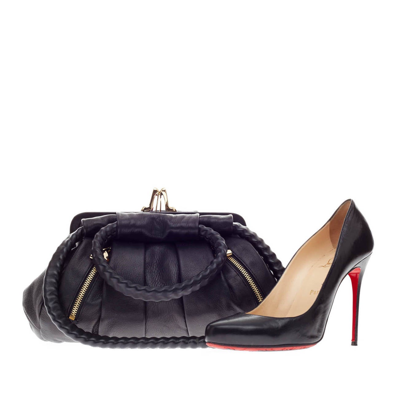 This authentic Christian Louboutin Loubette Leather in Small is a chic accessory to complement an equally stylish outfit. Crafted from smooth black leather and gold-tone hardware, this pleated frame bag features a stylish lady heel snap closure