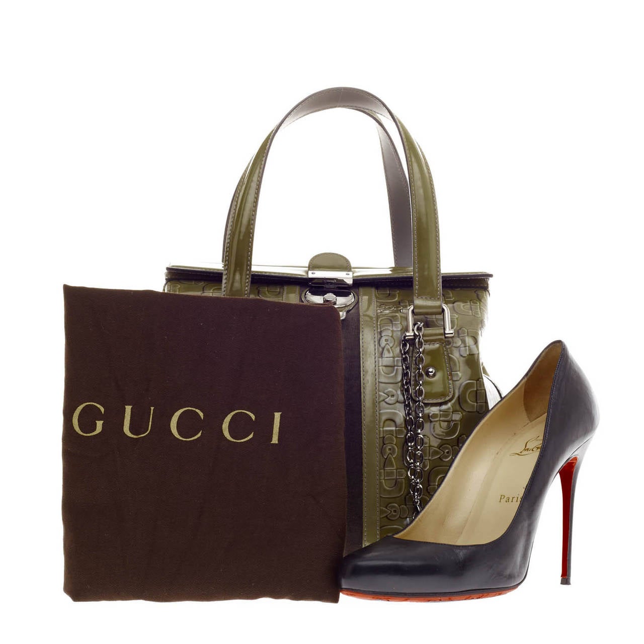 This authentic Gucci Treasure Boston Patent Small in rich olive is a stylish bag crafted with shiny patent leather with tonal velvet inlays coming down the middle. This unique satchel is accented with polished silver-tone hardware and decorated with