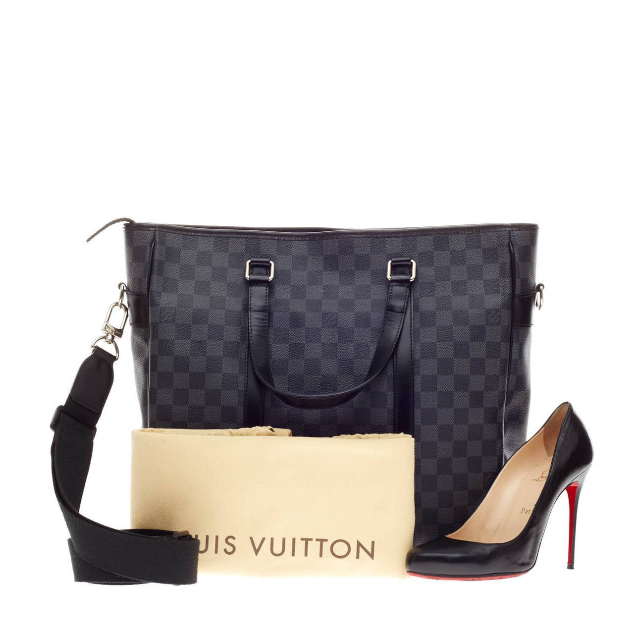This authentic Louis Vuitton Tadao Tote Damier size MM balances style and functionality perfect for everyday and work excursions. This tote features Louis Vuitton's signature Damier Graphite canvas print with smooth black leather trimmings accents