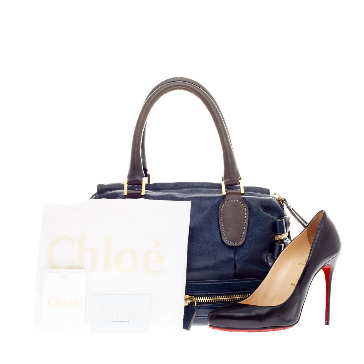 This authentic Chloe Andy Expandable Tote is a uniquely stylish yet practical bag with and expandable base. Crafted from sumptuous brown and deep blue lamb leather, this bag features gold-tone hardware, protective feet studs, dual-rolled handles,