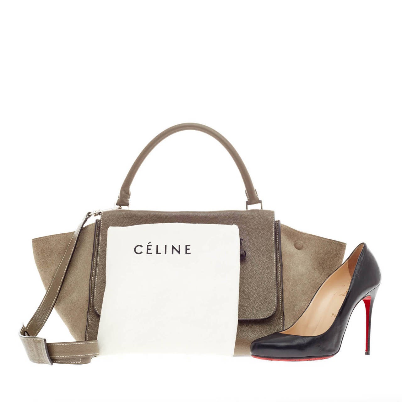 This authentic Celine Trapeze Suede in size Medium is a sleek and highly sought-after bag in a versatile neutral taupe palette. Crafted from sturdy pebbled leather with suede side wings, this popular minimalist satchel features a full frontal flap,