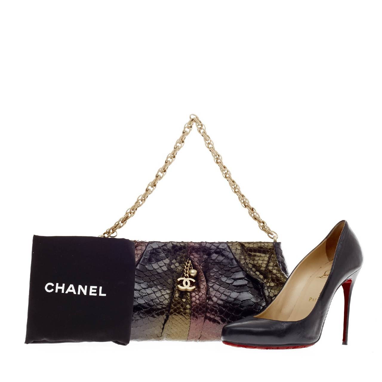 This authentic Chanel Chain Strap Pochette Multicolor Python will certainly add a pop of style to any casual and evening outfit. Constructed in multicolor ombre black, gold and deep purple python skin, this pleated clutch features a matte gold