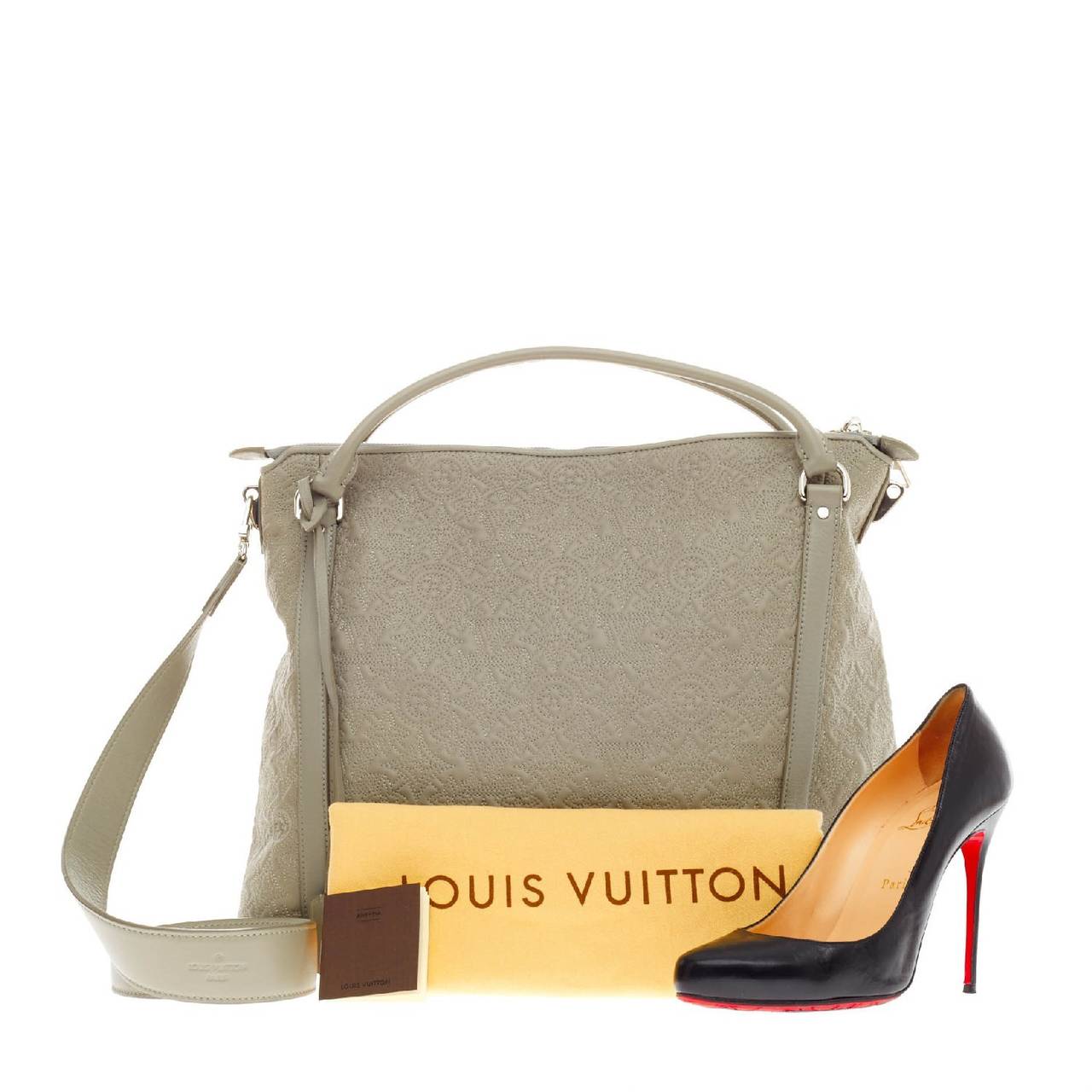 This authentic Louis Vuitton Antheia Ixia Leather MM is luxuriously crafted from grey soft lambskin showcased in Louis Vuitton's Spring 2010 Collection. Named after the greek goddess of flowers, this stunning tote is decorated in delicate