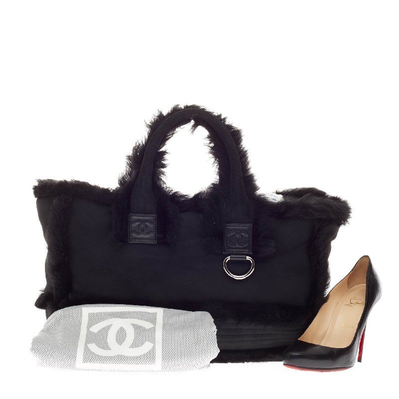 This authentic Chanel Handle Bag Leather with Fur Trim is a great addition to your Chanel collection. Crafted from supple black leather with fur trim details, this simple yet luxurious tote features double rolled handles with the iconic Chanel logo