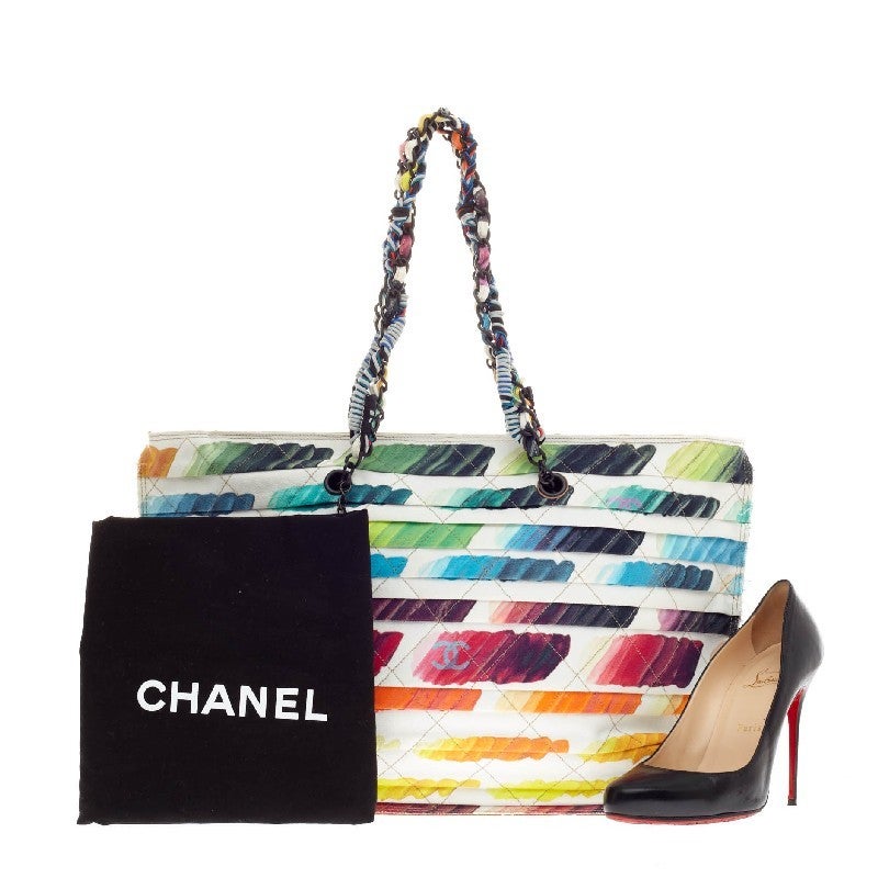 This authentic Chanel Colorama Shopping Tote Watercolor Canvas is a highly coveted accessory presented in Chanel’s Spring/Summer 2014 Collection. Constructed from multicolored toile canvas, this eye-catching artistic tote features woven chain