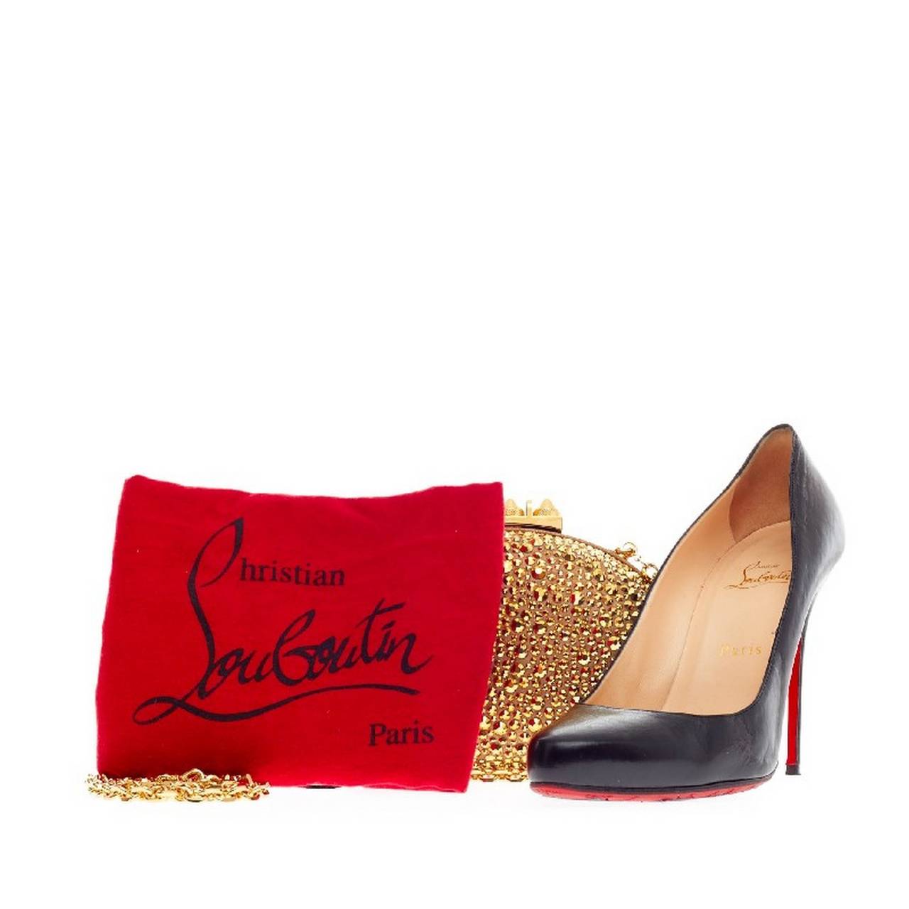 This authentic Christian Louboutin Mina Clutch Strass is a must-have accessory for any formal or evening event. Decorated in sparkling luminescent gold crystal embellishment, this eye-catching rounded clutch features gold-hardware accents and a