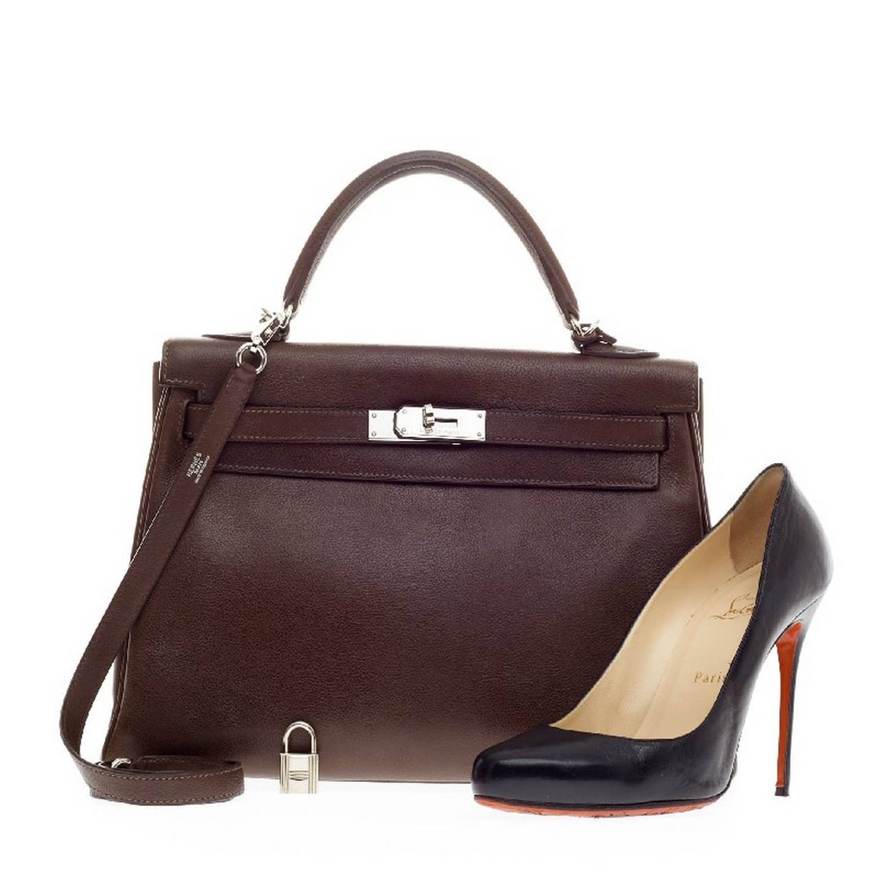 This authentic Hermes Kelly Havane Evergrain with Palladium Hardware 32 is as classic and timeless as they come. Designed in rich brown Havane evergrain leather and accented with polished palladium hardware, this Kelly showcases Hermes' beautiful