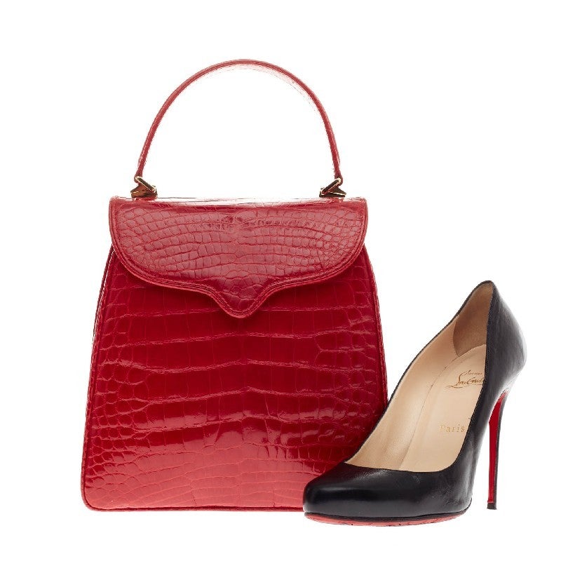 This authentic Lana Marks Princess Diana Frame Bag Alligator handbag is an exceptionally elegant masterpiece classic to Lana Marks. Handcrafted in genuine matte red positano crocodile skin, this simple yet luxurious structured handle bag features a