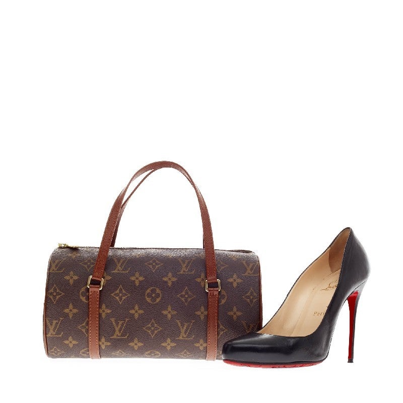 This authentic Louis Vuitton Papillon Monogram Canvas 26 is one of Louis Vuitton's iconic bags. The Louis Vuitton's classic brown leather trims and monogram canvas are true to the brand's aesthetic. The unique round shape and shoulder straps make