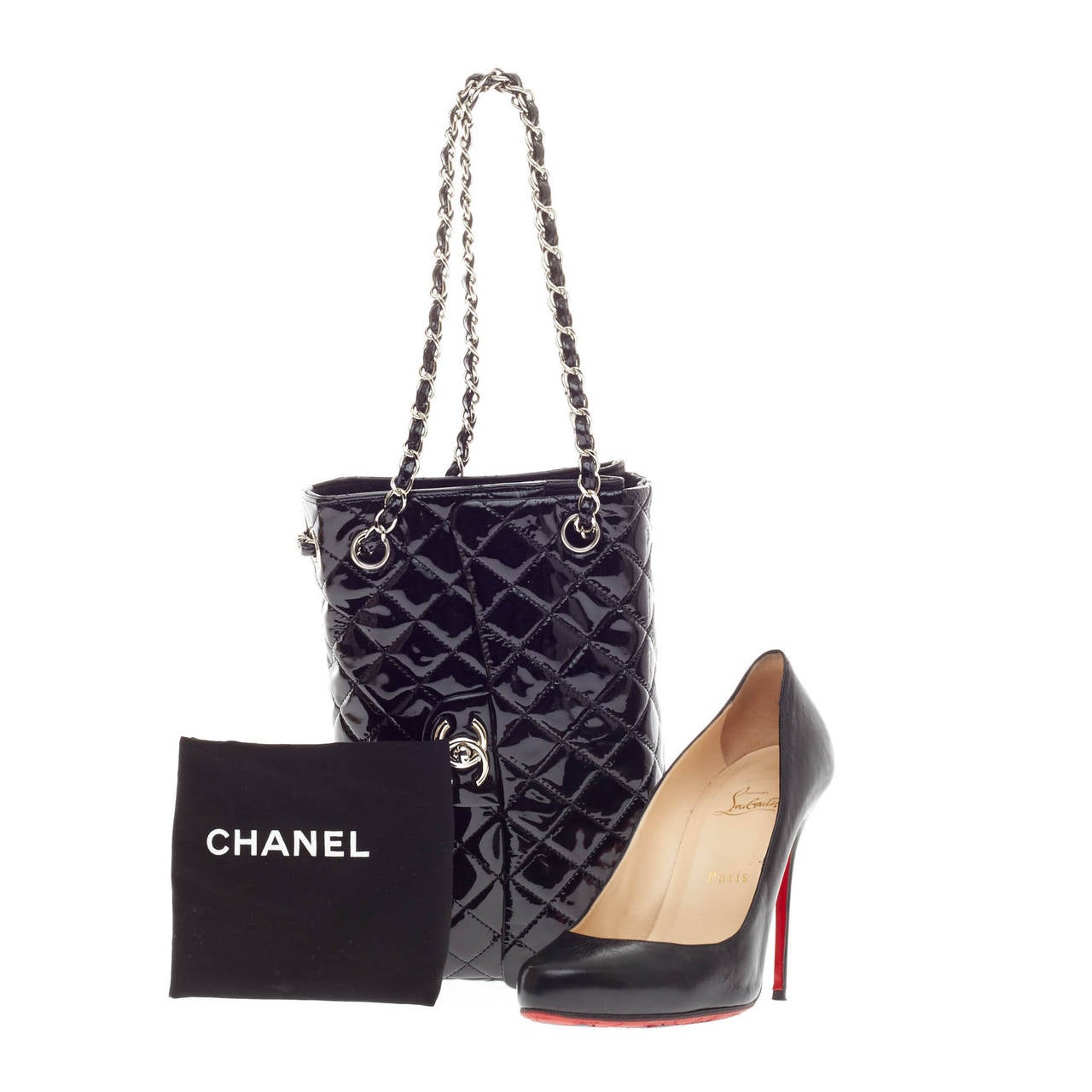 This authentic Chanel Upside Down Flap Bag Quilted Patent showcased in Chanel's Spring 2009 collection is designed as classic flap bag with a whimsical twist. Crafted from shiny black patent leather, the bag's leather woven-in straps are turned on