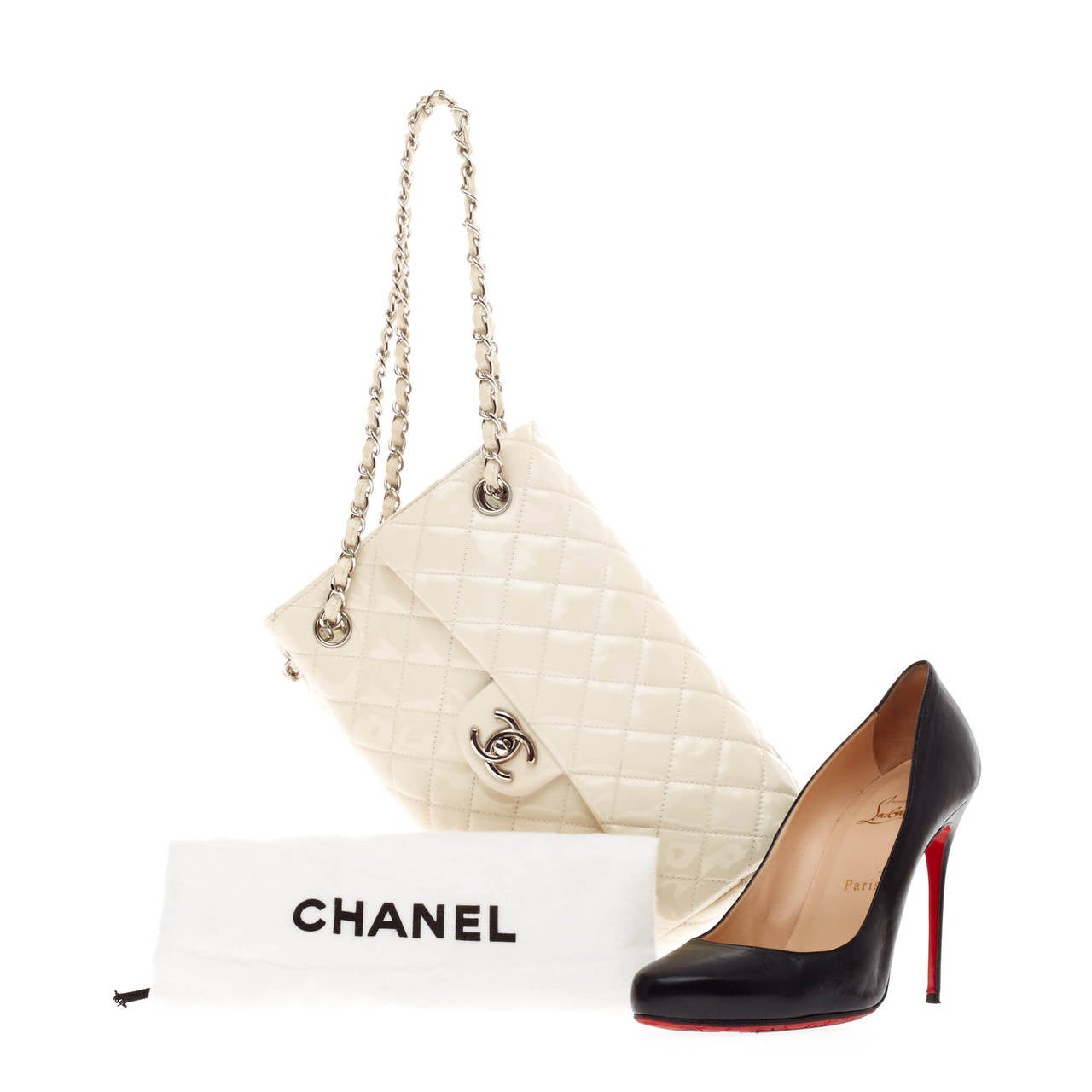 This authentic Chanel Upside Down Flap Bag Quilted Patent showcased in Chanel's Spring 2009 collection is designed as classic flap bag with a whimsical twist. Crafted from shiny white patent leather, the bag's leather woven-in straps are turned on