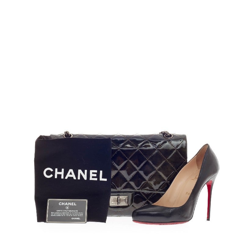This authentic Chanel Reissue 2.55 Patent  227 is a must-have classic for all fashion lovers. Crafted from metallic dark green patent leather, this beautiful oversized reissue flap showcases signature diamond quilting, silver chain shoulder strap,