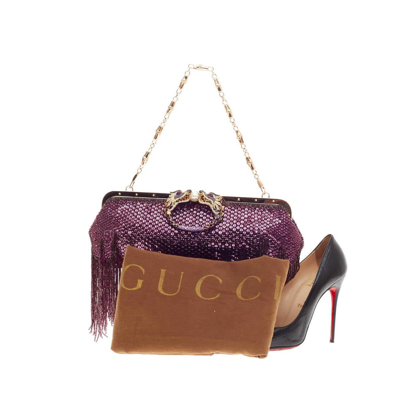 This authentic limited edition Gucci Beaded Fringe Evening Bag Crystal with Dragon Head Closure designed by Tom Ford for the designer's last show is an eye-catching runway accessory perfect for special occasions. Meticulously adorned in purple