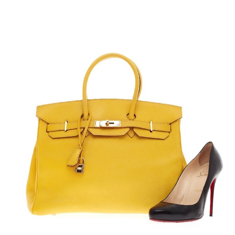 This authentic Hermes Birkin Jaune Clemence with Palladium Hardware 35 stands as one of the most-coveted bags fit for any fashionista. Constructed from sturdy bright yellow clemence leather, this stand-out tote features dual-rolled top handles,