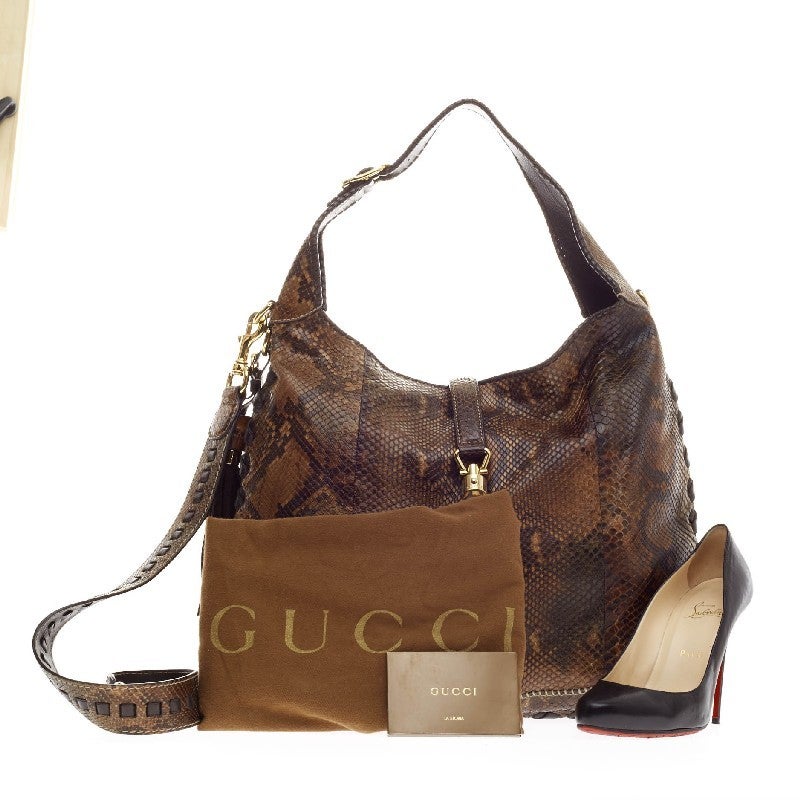 This authentic Gucci New Jackie Python Large is a must-have luxurious everyday hobo fit for the modern woman. Constructed from multicolor brown python skin, this bag features side fringe tassels, cross leather detailing, gold-tone hardware accents,