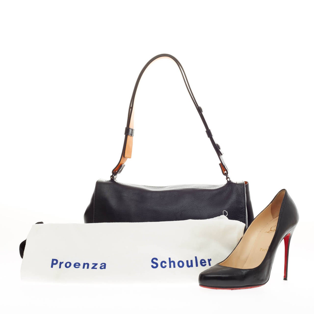 This authentic Proenza Schouler Courier Smooth Leather Medium is a minimalistic stylish bag loved by fashionistas. Crafted in supple black leather, this bag features a fold-over top with exterior back pocket, silver side snap studs and adjustable