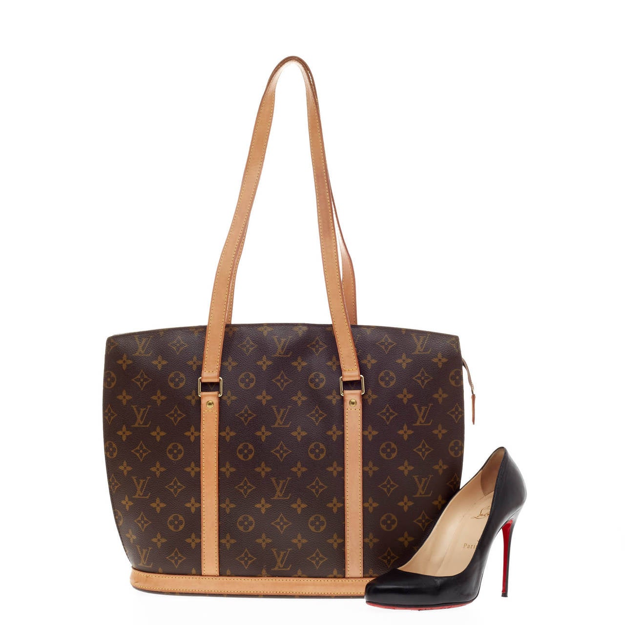 This authentic Louis Vuitton Babylone Monogram Canvas is a stylish and durable tote that is ideal for everyday use. Crafted from monogram canvas, this bag features natural vachetta cowhide leather straps and trims, gold-tone hardware accents and a