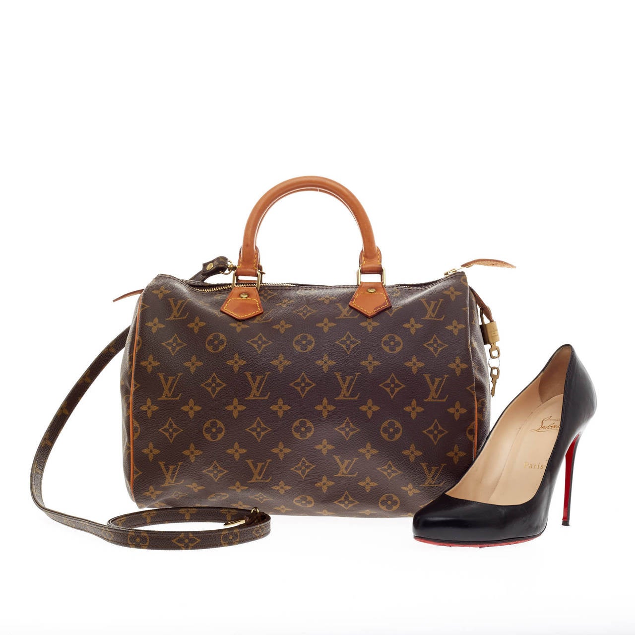 This authentic Louis Vuitton Speedy Bandouliere Monogram Canvas 30 is a classic must-have. Constructed in Louis Vuitton's classic monogram canvas print, this iconic Speedy is spacious and light, making it ideal to use everyday. It is finished with