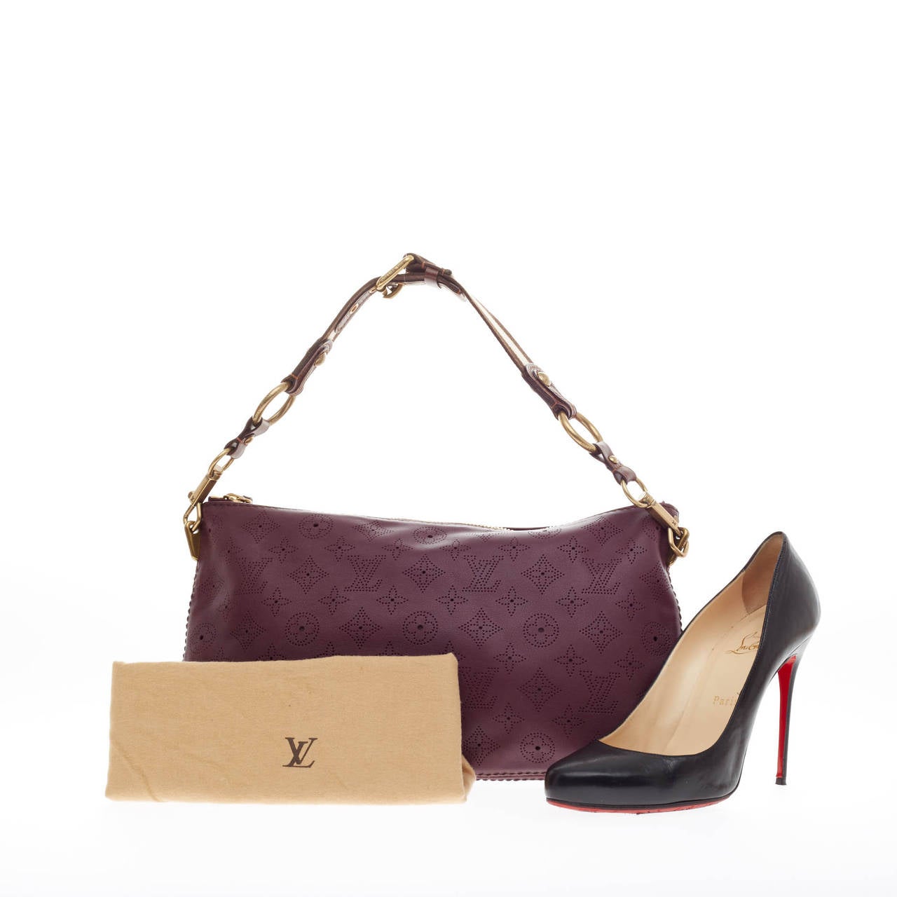 This authentic Louis Vuitton Onatah Pochette Mahina Leather is the perfect accessory to store your everyday essentials. Crafted from deep plum purple perforated monogram leather, this chic oversized pochette features detachable shoulder strap and