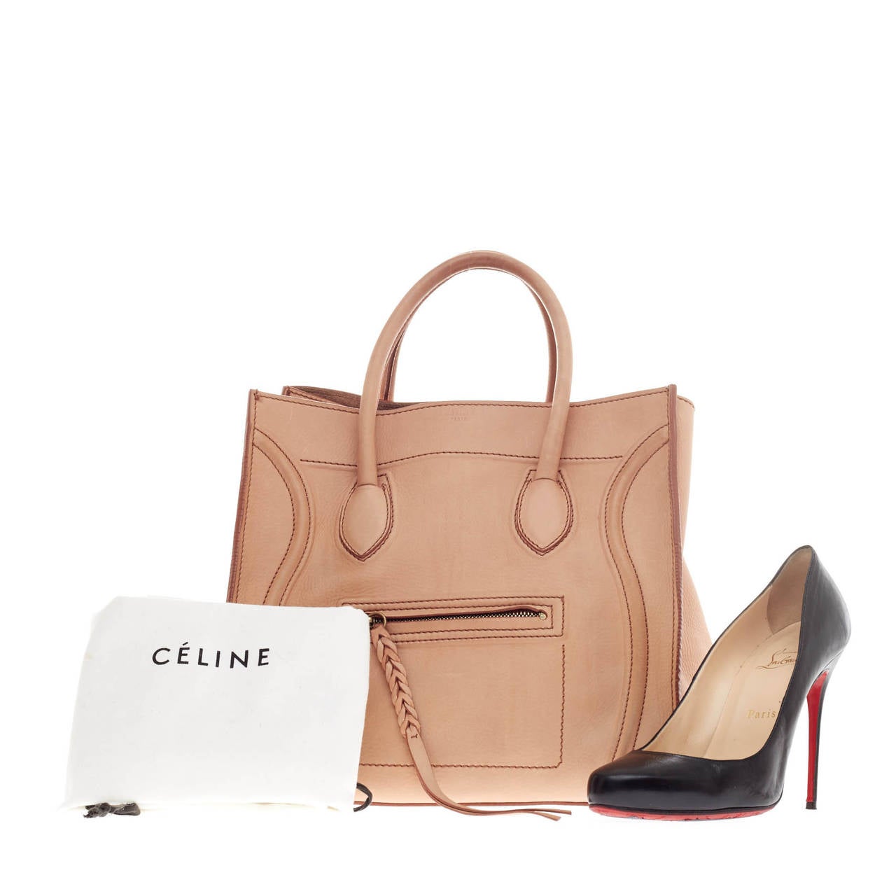 This authentic Celine Phantom Grainy Leather in size Medium is one of the most sought-after bags beloved by fashionistas. Crafted from blush pebbled leather, this oversized minimalist tote features a braided zipper pull, dual rolled handles, matte