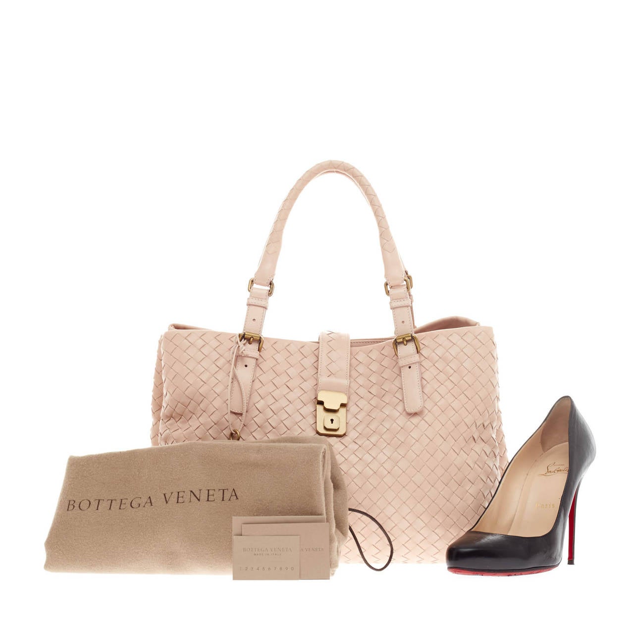 This authentic Bottega Veneta Roma Intrecciato Nappa Large in Pale Pink is a finely crafted tote that exudes an understated elegance. Made from calf leather woven in Bottega Veneta's signature intrecciato method, this functional and feminine tote