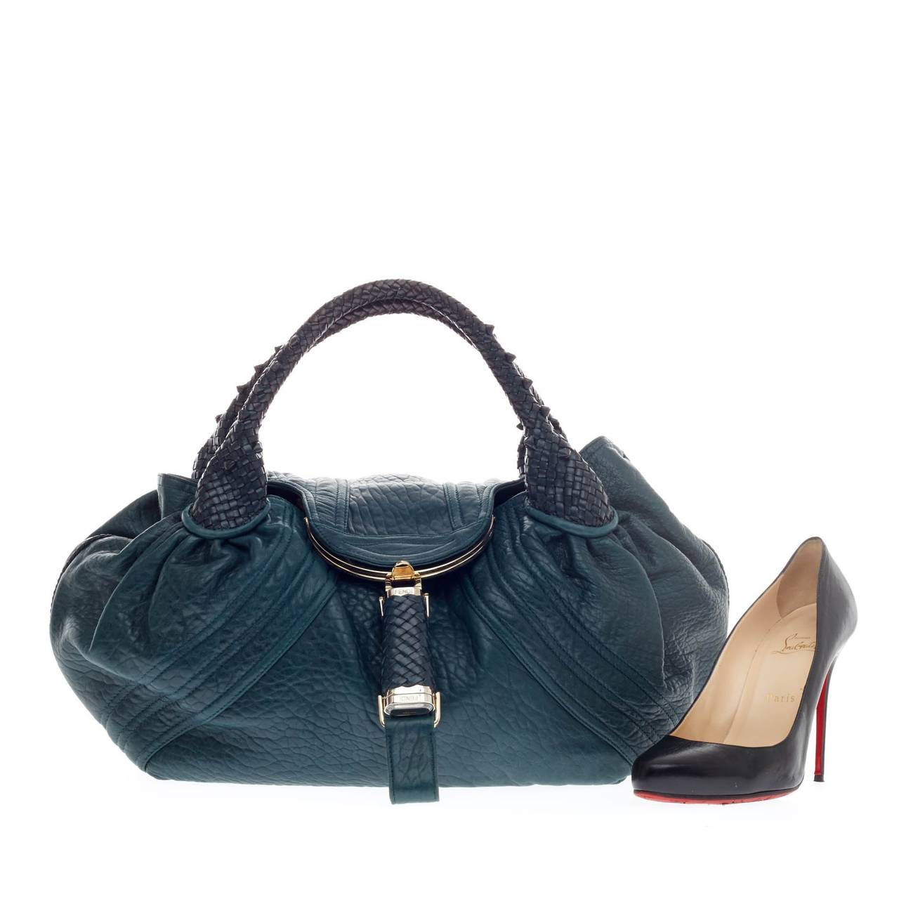 This authentic Fendi Spy Bag Leather showcases one of the brand's most popular designs. Constructed from vivid blue green leather, this alluring bag features spiked braided woven leather handles and a 