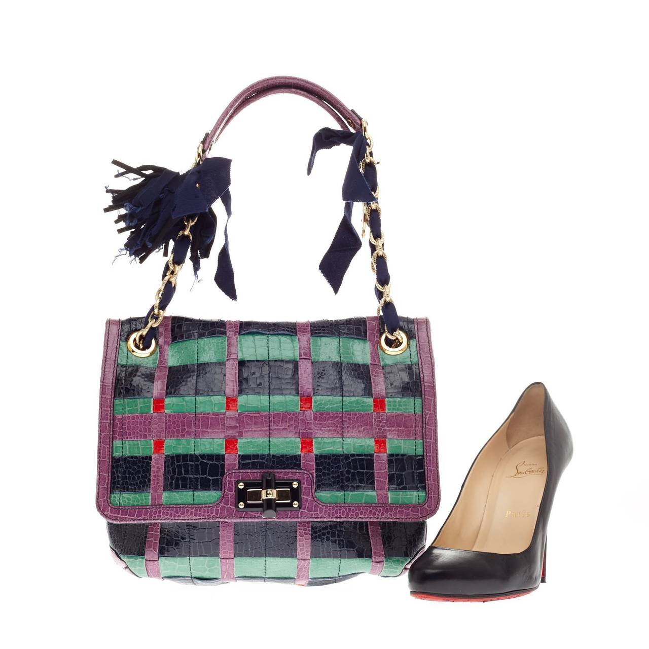 This authentic Lanvin Happy Shoulder Bag Embossed Crocodile in vibrant teal, navy blue, red and purple embossed crocodile leather showcases a funky and playful plaid design. This fold-over flap shoulder bag features a resin turn-lock closure and
