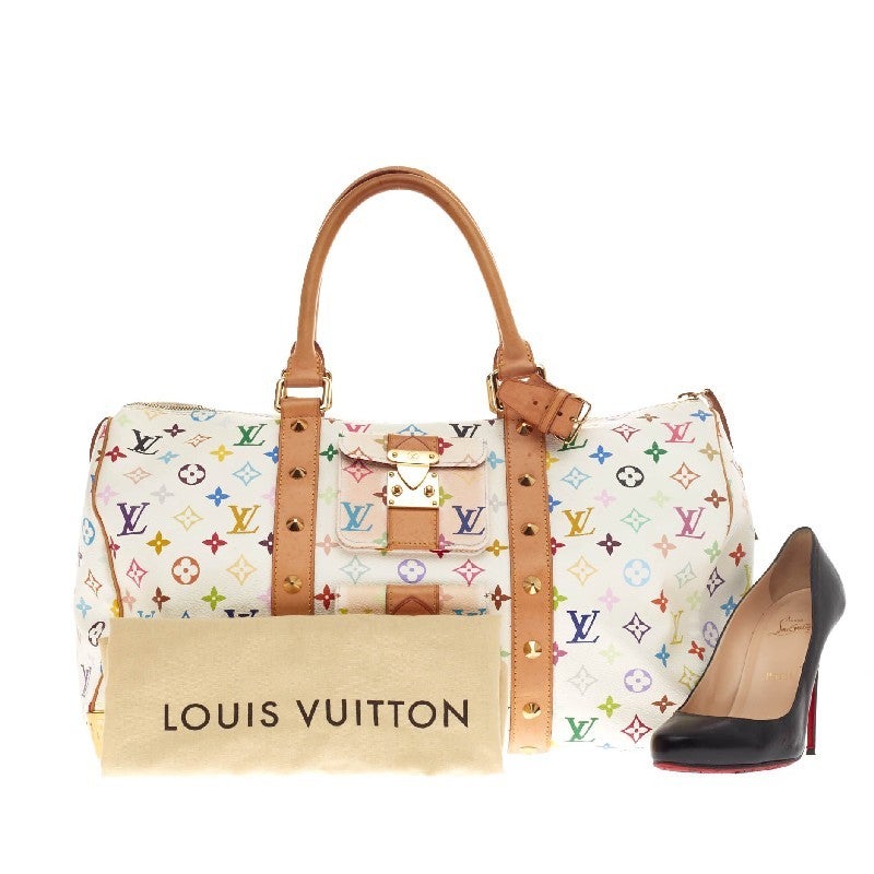 This authentic Louis Vuitton Keepall Monogram Multicolor in size 45 is a vibrant and glamorous duffle perfect for traveling in style or for a weekend getaway. Crafted with Takashi Murakami's white multicolor monogram print, this modern
