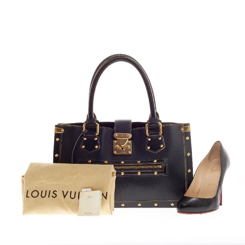 This authentic discontinued Louis Vuitton Suhali Le Fabuleux Leather exudes an edgy-chic style perfect for everyday. Crafted from sleek black fine goat skin leather, this stylish bag features dual-rolled leather handles, four gold-tone corner