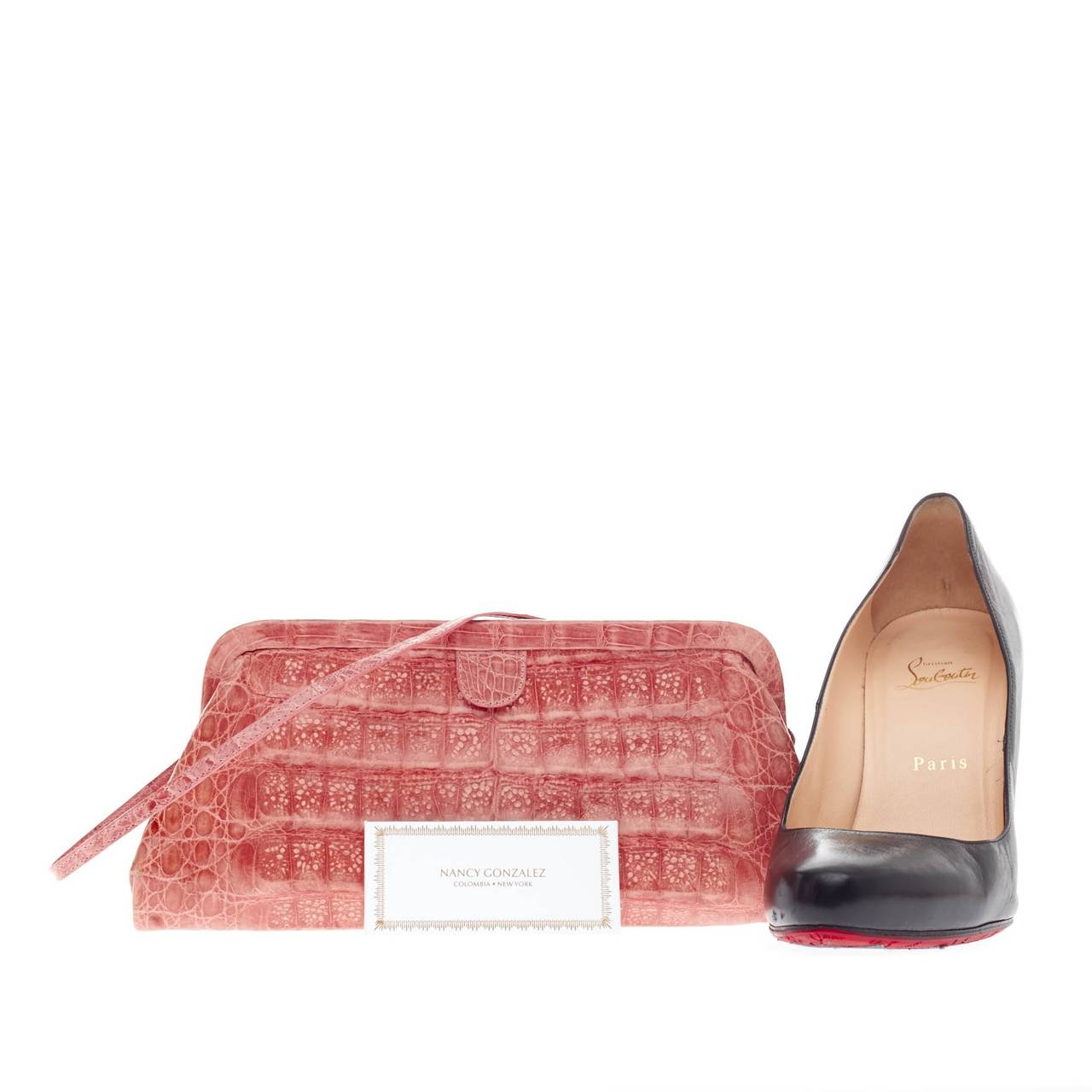 This authentic Nancy Gonzalez Convertible Clutch Crocodile Small is luxuriously elegant and perfect for a day or a night out. Highly crafted from genuine pink crocodile skin, this beautiful clutch opens to a tan suede interior showcasing zip pocket