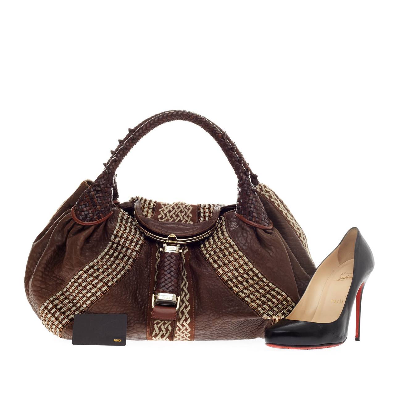 This authentic Fendi Spy Bag Beaded Leather showcases one of the brand's most popular designs. Constructed from rich brown leather with white and copper bead detailing, this alluring bag features spiked braided woven leather handles and a 