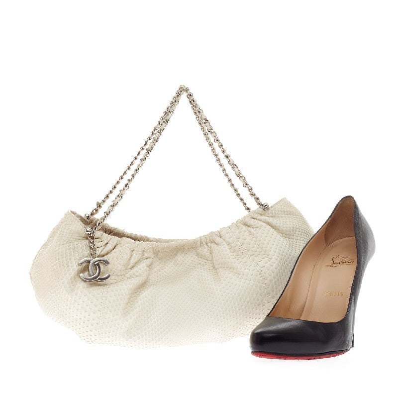 This authentic Chanel Pleated Chain Hobo Python Small showcases a baguette silhouette and pleated construction making this a chic yet easy-to-wear bag. Constructed in striking white genuine python, this petite bag features a double leather chain