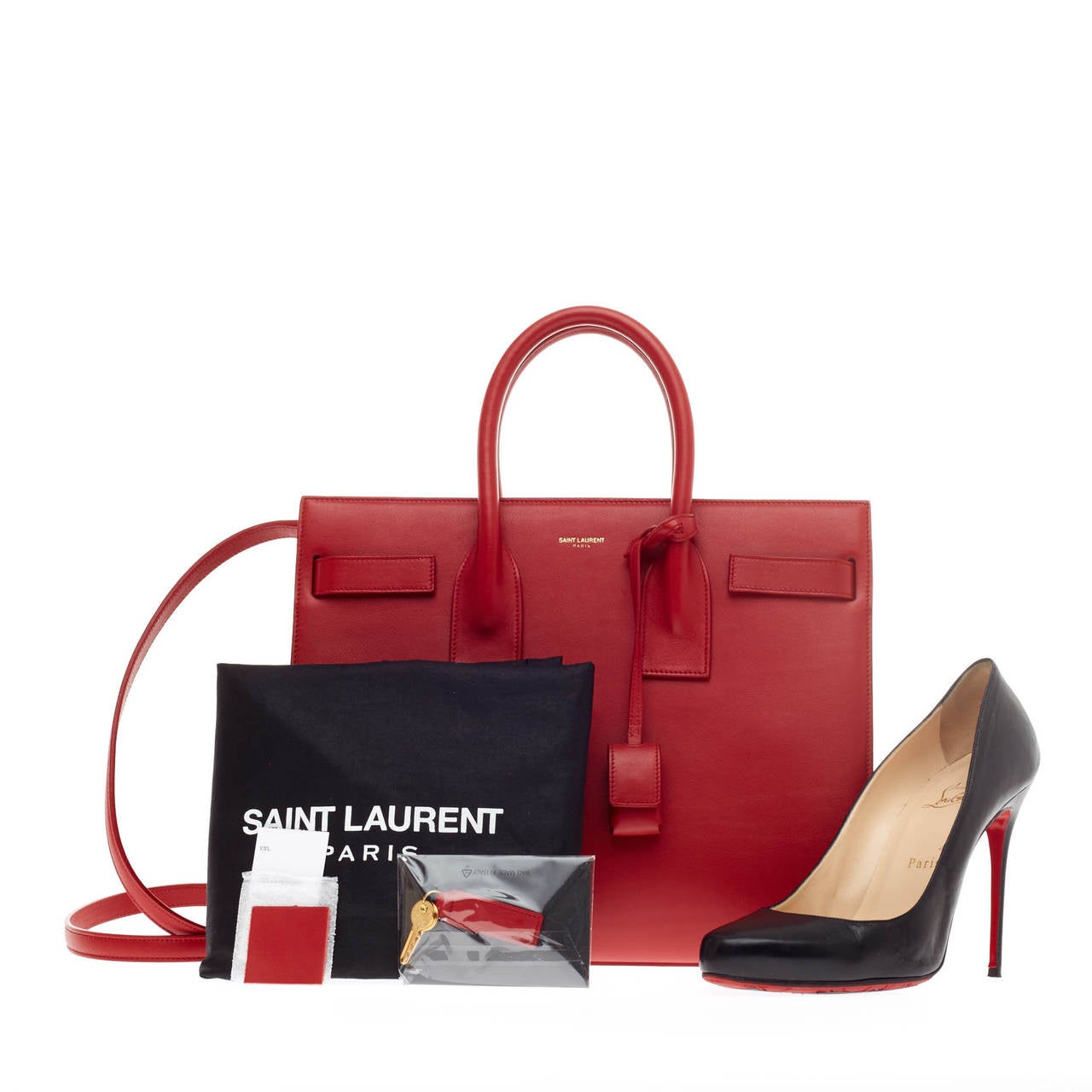 This authentic Saint Laurent Sac De Jour Tote Leather Small is a sleek yet elegant bag synonymous with the brand's classic aesthetic. This sought-after structured tote is crafted from vivid red vermillion leather, a gold Saint Laurent embossed