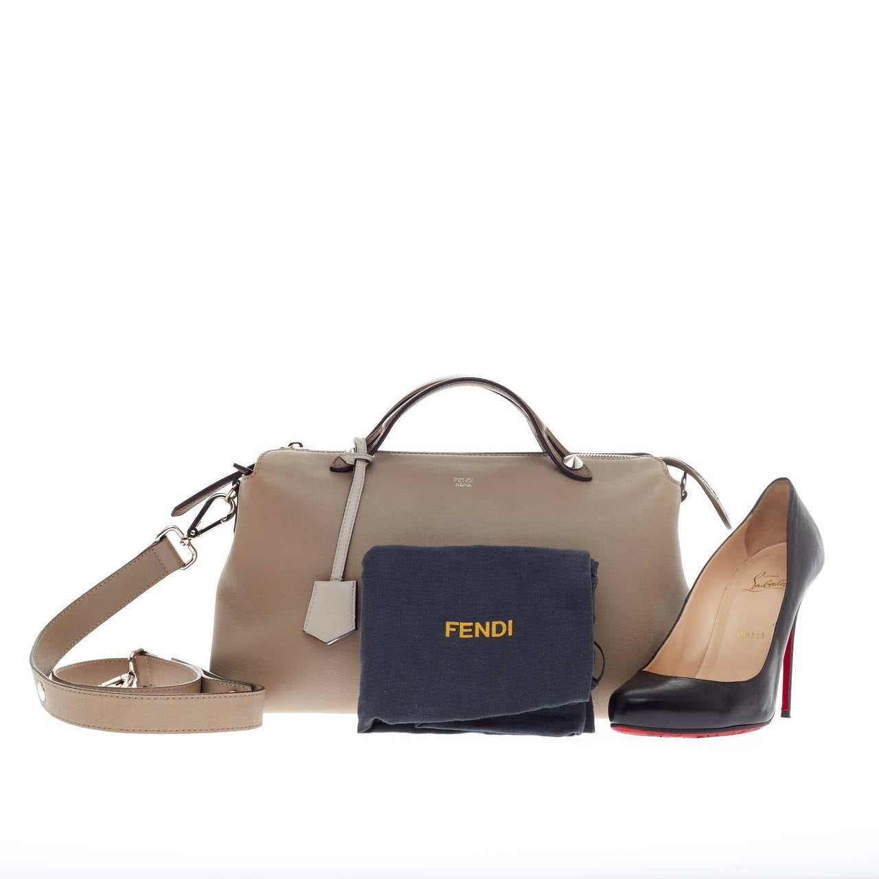 This authentic Fendi By The Way Satchel Calfskin Large showcases a modern, understated style admired by every fashionista. Constructed from smooth neutral taupe and brown calfskin leather, this minimalist and functional duffle features dual flat top