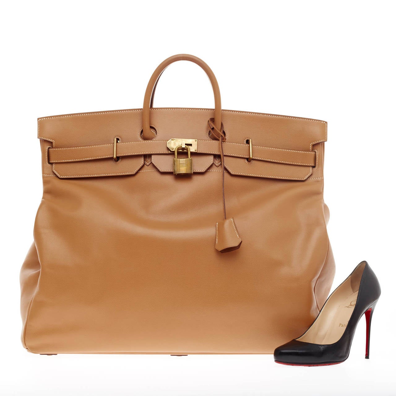 This authentic, timeless Hermes Birkin HAC Gold Veau Courchevel Leather with Brass Hardware is both elegant and understated. Crafted from vivid gold courchevel leather, this larger-than-life Birkin HAC has taller proportions and features shorter