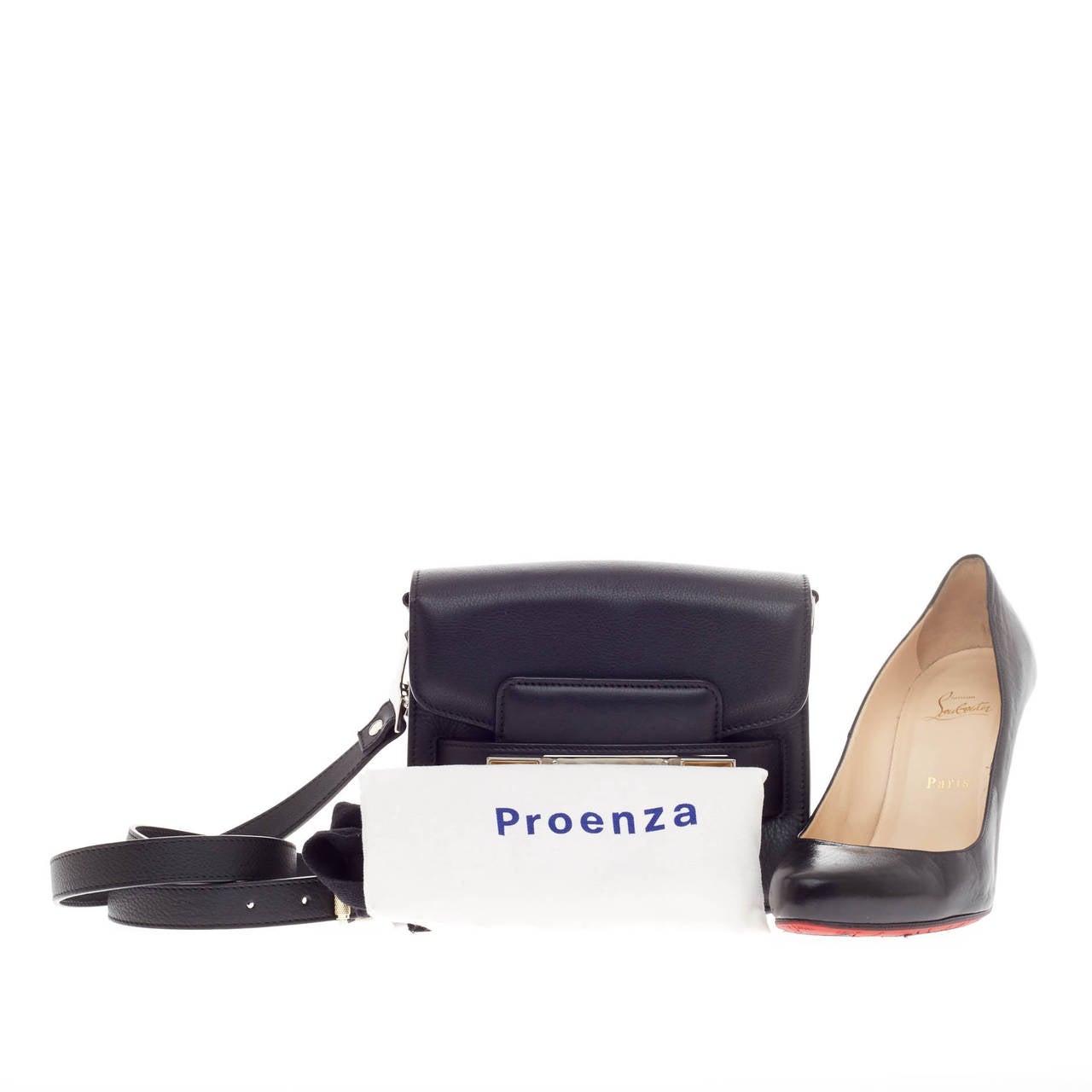 This authentic Proenza Schouler PS11 Classic Shoulder Bag Leather Tiny loved by fashionistas is constructed from sleek black leather perfect for the on-the-go woman. Its mini square body is accented with silver-tone hardware accents, gold inverted