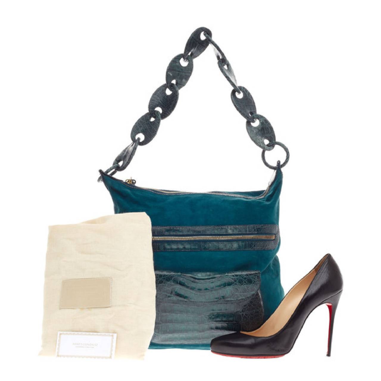 This authentic Nancy Gonzalez Front Pocket Hobo Crocodile and Suede showcases a casual elegance synonymous with the brand. This exotic hobo shoulder bag is crafted with a beautiful soft blue toned suede and accented with blue crocodile skin. The bag