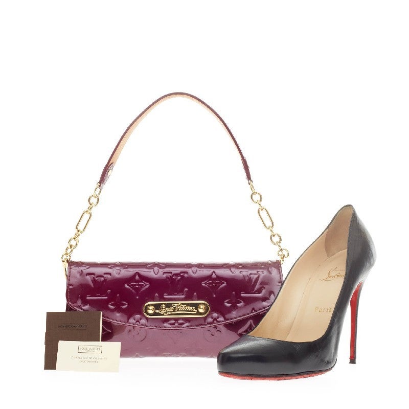 This authentic Louis Vuitton Sunset Boulevard Vernis Leather Clutch is perfect for night outs. Crafted in stunning Violette embossed monogram vernis, this clutch is accented with gold-tone hardware and removable chain link leather strap that allows