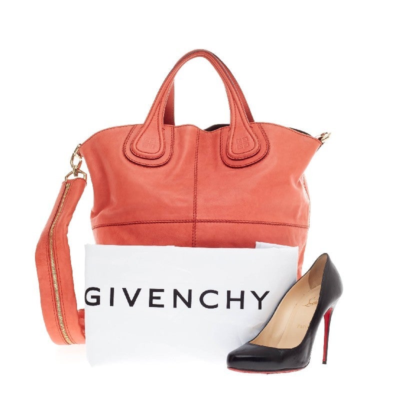 This authentic Givenchy Nightingale Tote Leather Medium is a stylish and functional carry-all fit for all needs. Constructed in stunning coral leather, this elongated shopper tote is defined by its stitched quarters and embossed Givenchy logo emblem