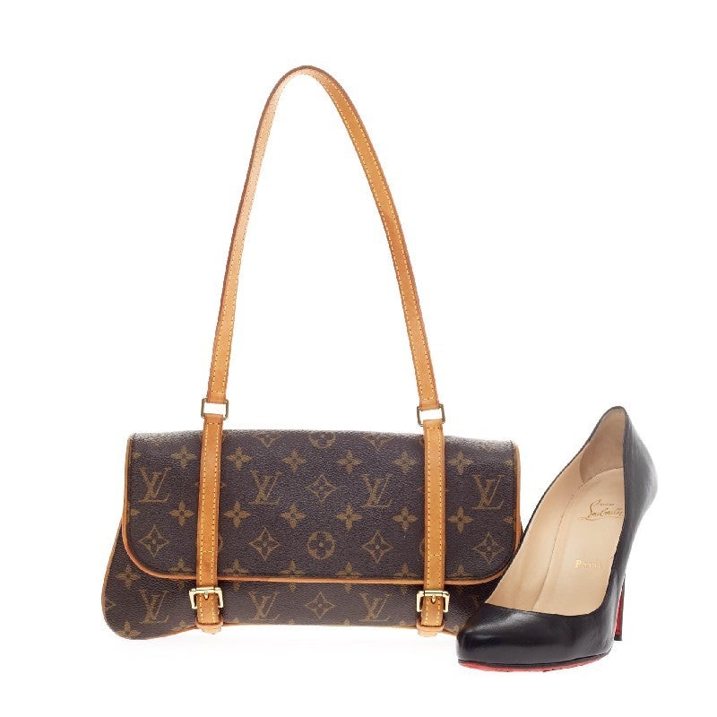 This authentic Louis Vuitton Marelle Shoulder Bag Monogram Canvas is a chic accessory that is perfect for on-the-go moments. Featuring the brand's monogram canvas print with yellow contrast stitching, this stylish bag features gold-tone hardware