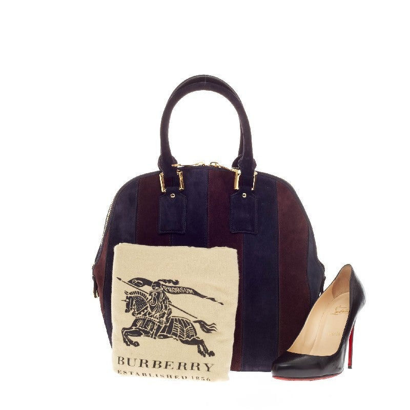 This authentic Burberry Orchard Bag Striped Suede Medium is perfect for day to evening casual look. Crafted in navy and plum suede with a striped design, this bag features a vintage-inspired bowling shaped design with dual-rolled top handles