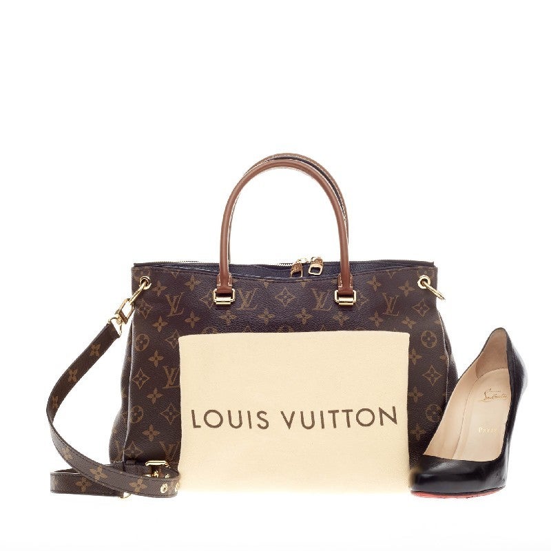 This authentic Louis Vuitton Pallas Tote Monogram Canvas in classic Noir Black is a mix of classic style with modern functionality. Released first in 2011, this structured satchel features the brand's signature monogram canvas print with peeking