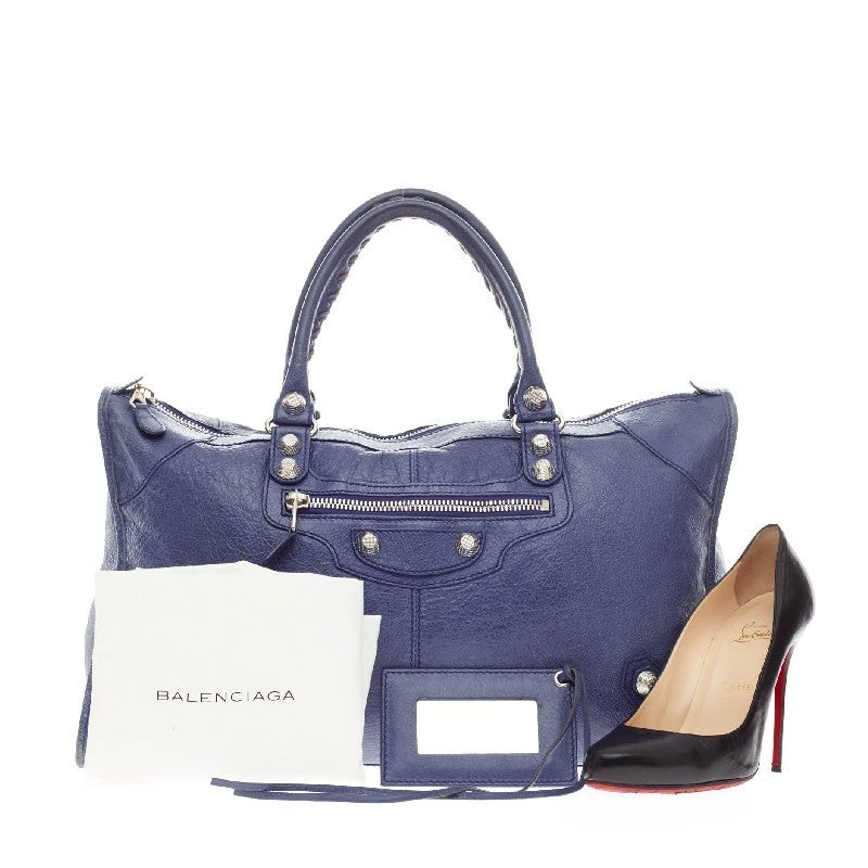 This authentic Balenciaga Work Giant Studs Leather s true to the brand's easy, luxe aesthetic. Crafted in soft, blue lavender leather, this oversized tote features signature giant studs, a front zip pocket and accented with silver-tone hardware,