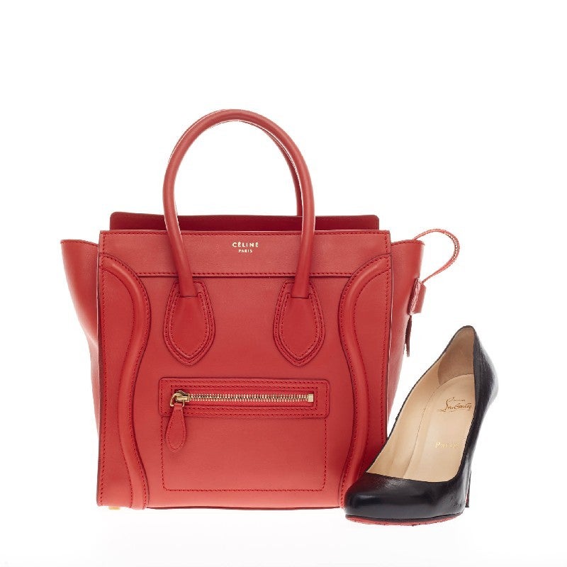 This authentic Celine Luggage Smooth Leather Micro is the quintessential It bag perfect for the modern woman. Crafted in lipstick red smooth leather, this popular tote features gold Celine logo detail, brass-tone hardware accents, dual-rolled