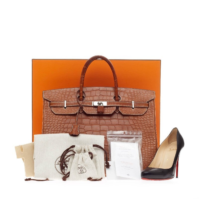 This authentic Hermes Birkin Fauve Barenia Matte Alligator with Palladium Hardware 40 stands as one of the most-coveted pieces for any serious Hermes lover. Finely crafted in luxurious matte fauve alligator skin and polished palladium hardware, this